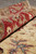 Rolled edge detail showing wool pile depth, crimson border and soft vegetable dyed colors