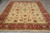 8 x 12 Indian Ziegler rug on grey tile, ivory field framed by crimson border