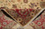 Folded back corner revealing dense hand-knotted weave, cotton foundation and clean ivory fringe ends