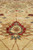 Macro shot of hand-spun wool pile showing a red and teal floral motif