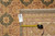 Back of rug with inventory tag reading 8 x 10 and tape measure for scale