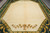 10'5 x 13'10 Indian rug close-up showing open beige field and gold floral spray