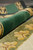 Macro detail of thick half inch wool pile in forest green and olive tones