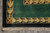 Corner detail with gold arrowhead border, brown cross rosette and black guard band