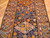 Close-up of Caucasian Kazak geometric medallions, eight pointed stars and hooked motifs in hand-knotted wool