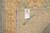 Back of hand-knotted Pakistani runner folded to show tight weave, woven mark and dealer tag