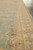 Detail of golden beige multi band border and guard stripes framing the pale green field