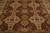 Close field view showing gold cartouches, olive green vines and burgundy ground on wool pile
