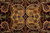 Gold palmette flanked by curling paisley leaves on deep burgundy, hand-knotted wool detail