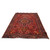 6'6" x 9'2" Persian wool rug photographed at an angle on a white studio background