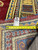 Back tag marked rug number 991252 with tape measure across the yellow Kazak border