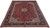 Angled view of a 10x13 red Kashan wool rug showing full medallion and navy border