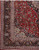 Corner detail showing navy turtle palmette border, ivory spandrel and dense all over floral vines