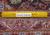 Back of the 9'10" x 13'2" hand-knotted Kashan beside a ruler showing knot density