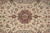 Close-up of the burgundy star medallion surrounded by scrolling vines and small rose blossoms
