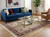 Living room styling with the 6'1" x 9'2" wool and silk rug under a glass coffee table