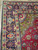 Close-up of navy main border with turquoise palmettes, rose blossoms and ivory guard stripe detail