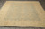 Angled floor view of 9x11 hand-knotted wool Chobi rug with cream fringe and floral corners