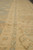 Ivory border detail with guard stripes, pale blue tracery and gold scrolling leaves in wool