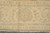 End border and fringe detail of the 9x11 Chobi rug showing the gold palmette repeat