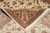 Folded corner revealing back knot density and the brown cartouche motifs of the border
