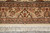 End border close-up with central cartouche, floral guard stripes and hand tied ivory fringe