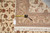 Tape measure and original hand woven Oriental rug tag laid across the folded corner