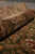 Rolled edge of the green Jaipur rug revealing thick wool pile and flexible handle