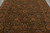 Olive, gold and rust floral vinework covering the deep green field of this wool rug
