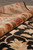 Rolled edge showing thick wool pile depth, ivory border flowers and near-black field