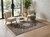 Midnight blue Isfahan rug grounding two cream boucle chairs beside a fiddle leaf fig in a sunlit room