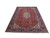 Angled view of 7'6" x 10'10" hand-knotted wool Ardebil rug in brick red and navy