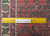 Ruler close-up over the wool pile proving hand-knotted construction and knots per square inch on this Persian runner