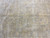 Field detail with soft camel florals, faint storage fold line and natural abrash banding