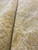Rolled edge close-up showing dense wool pile depth, knot structure and warm gold coloring