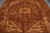 Close geometric medallion detail with sage green leaves, apricot palmettes and rosewood brown open field
