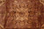 Eight point star medallion in beige and rust surrounded by curling leaf forms on brown
