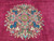 Macro shot of the medallion: indigo roses, sage leaves and pink blossoms on raspberry ground