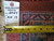 Back tag marked rug number 6024 and size 9.10 x 13 beside tape measure on weave