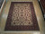 8'9" x 11'4" Indian Heriz design rug shown flat on light wood showroom floor