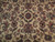 Close-up of rosette center, curling serrated leaves and rose palmettes on cream wool field