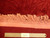 Ruler beside the rose fringe and end webbing confirming authentic hand-knotted construction and thick wool pile