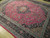 Angled floor view highlighting navy main border, light blue guards and berry rose open field