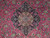 Close-up of the navy lobed medallion with camel rosette, pink blossoms and curling vines