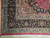 Corner detail showing camel spandrel, layered guard borders and ivory cotton fringe on wool pile