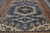 8'11" x 12' Indian wool rug angled overhead, stepped ivory spandrels and slate gray field