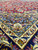 Corner detail with sky blue spandrel, ivory guard border and navy palmette main border