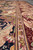 Low-angle detail of guard stripes dividing the black field from the deep burgundy outer border
