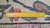 Ruler across the weave measuring knot density beside the ivory fringe and end finish