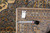 Back of the 9'1" x 12'6" Kashan rug with tape measure and genuine hand woven tag